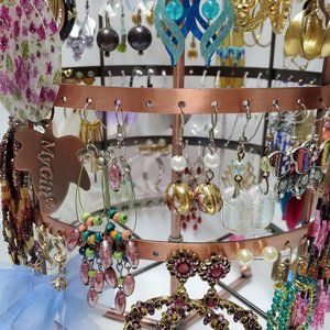 Carousel with 64 pairs of fashion earrings. . All earrings are for pierced ears.